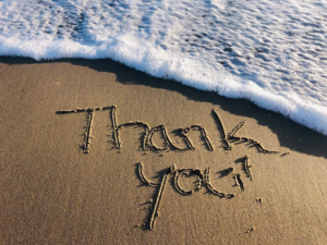 thank you written in the sand