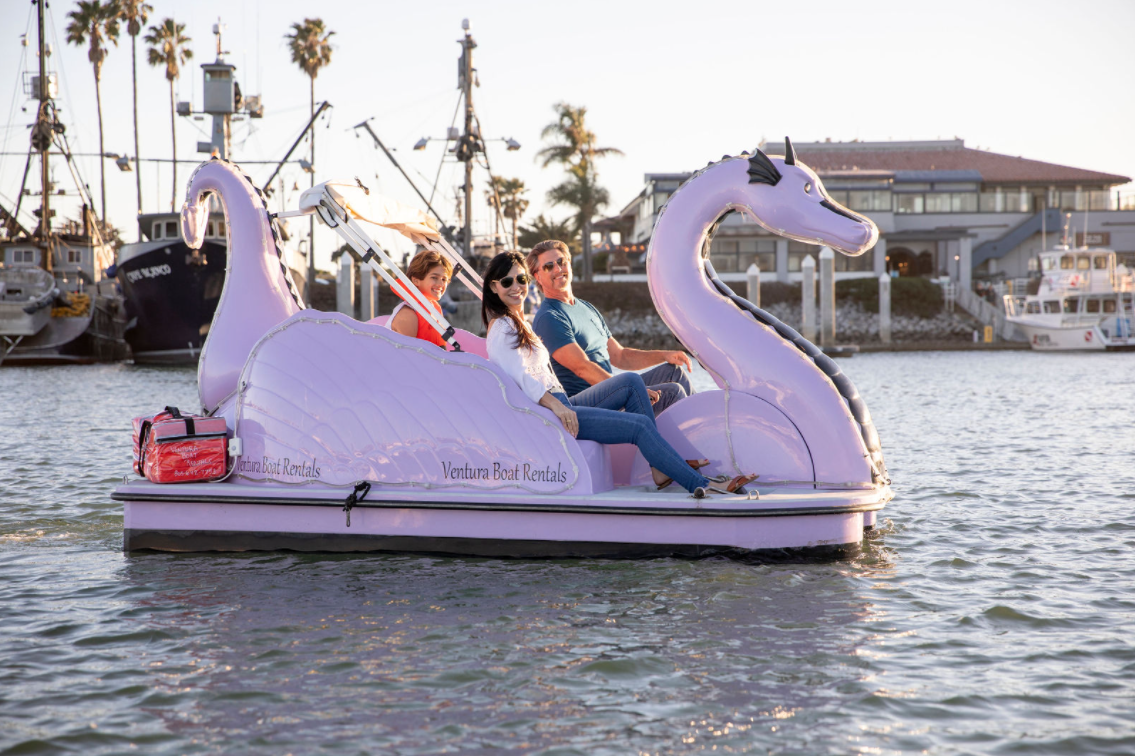 Photo of a family on a purple dragon pedal boat in the Ventura Harbor