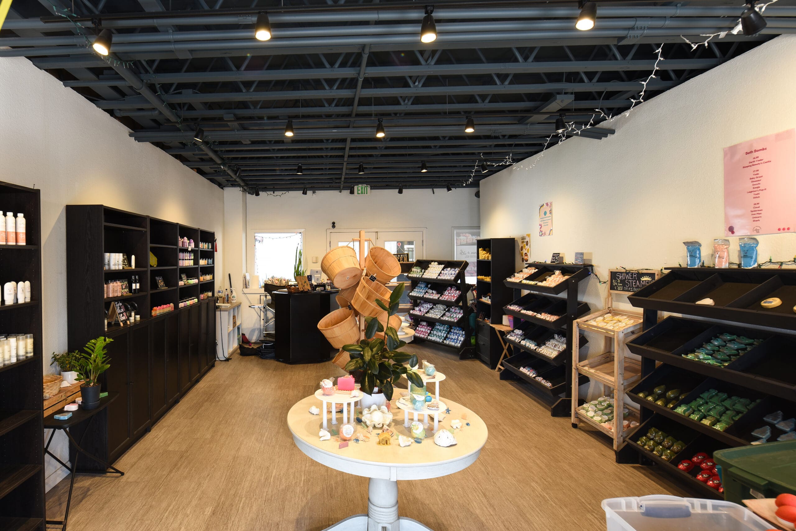 A neatly organized store with shelves of beauty products, a central display table, and soft lighting.