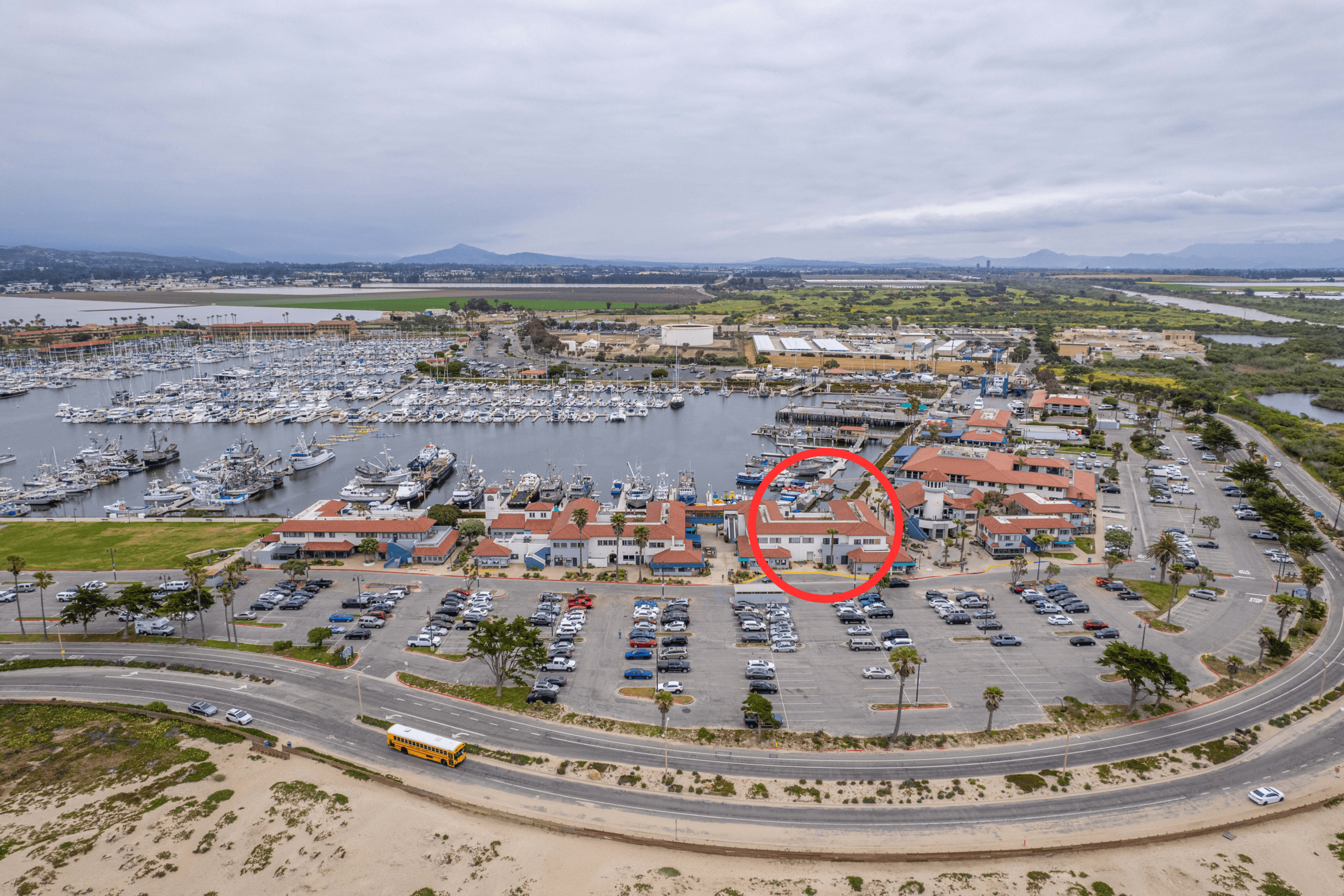 Ventura Port District marina and waterfront with parking and surrounding buildings.